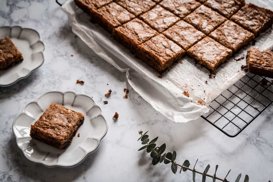 butterscotch dark chocolate bars cooling on a marble countertop and backlit with natural light