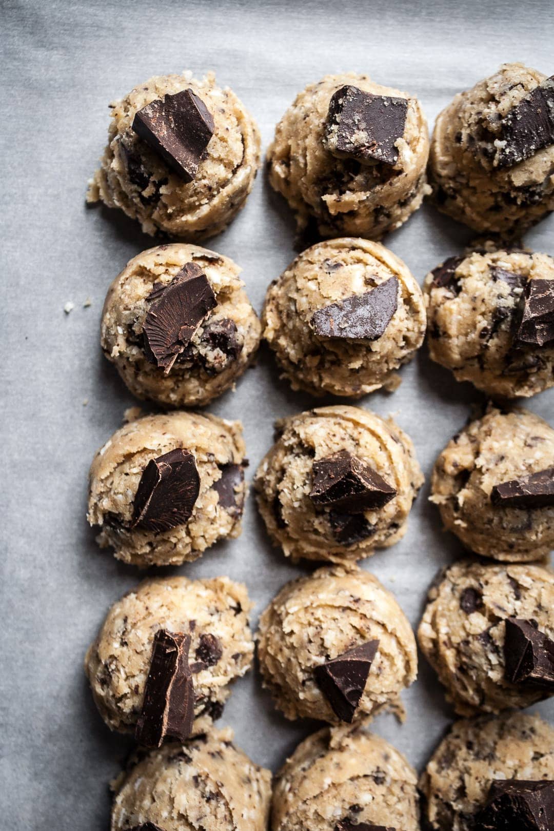 Top view close up of scoops of cookie dough with chocolate chunks on top