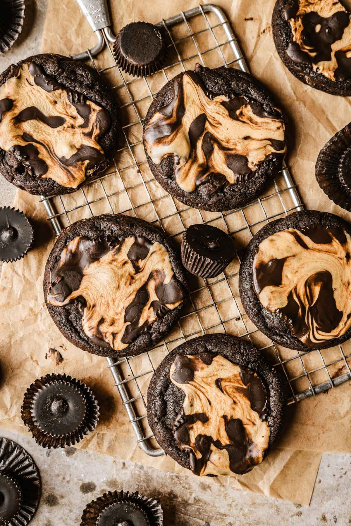 Cooled chocolate peanut butter cup cookies on a metal cooling rack.