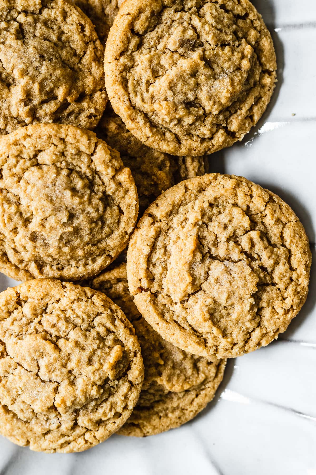 A close up of cookies on a fluted white ceramic serving plate.