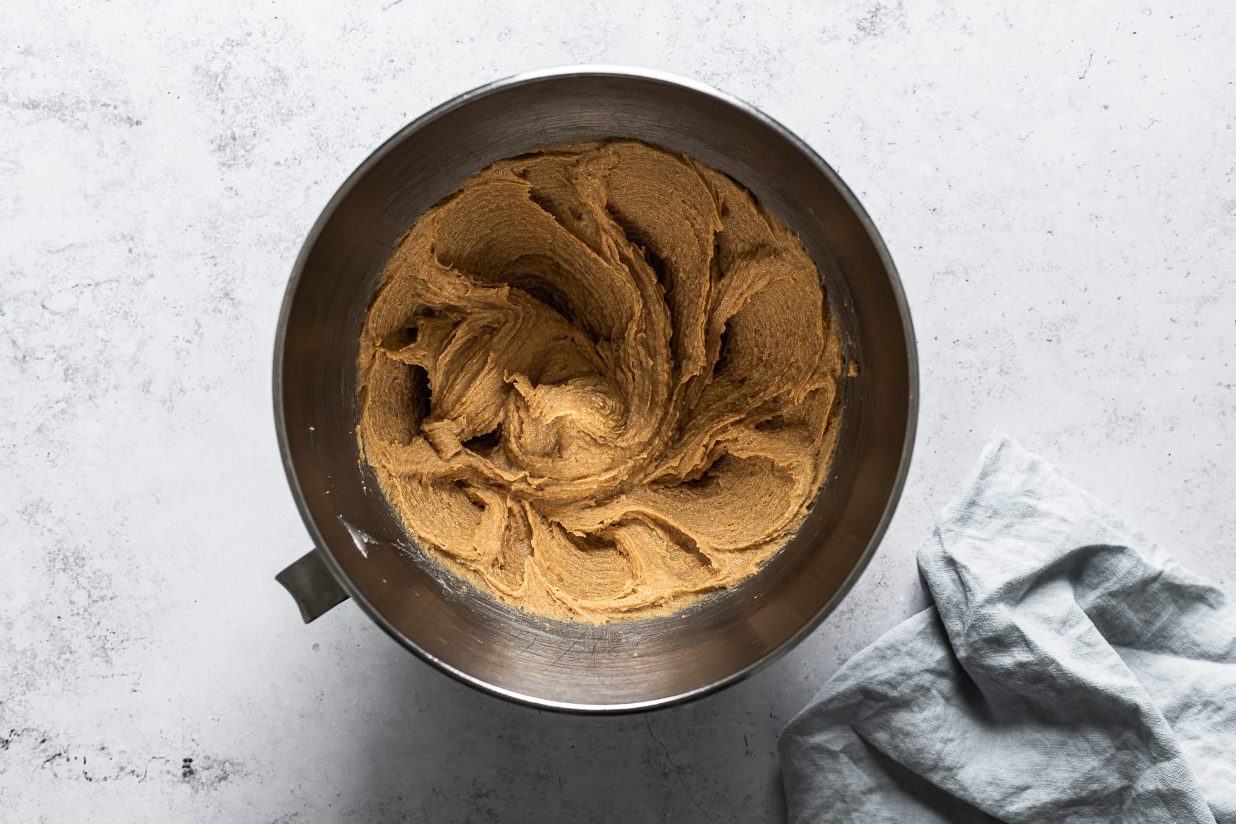 Process photo of cookie dough with wet ingredients mixed in.