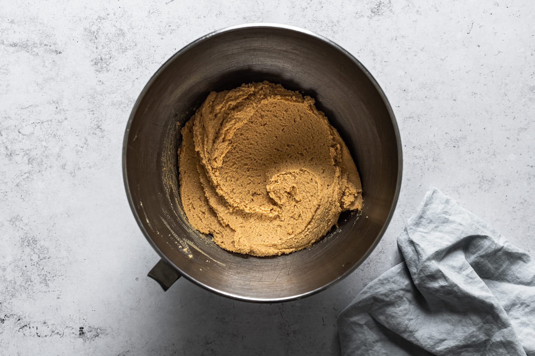 A process photo showing a mixing bowl of peanut butter cookie batter.