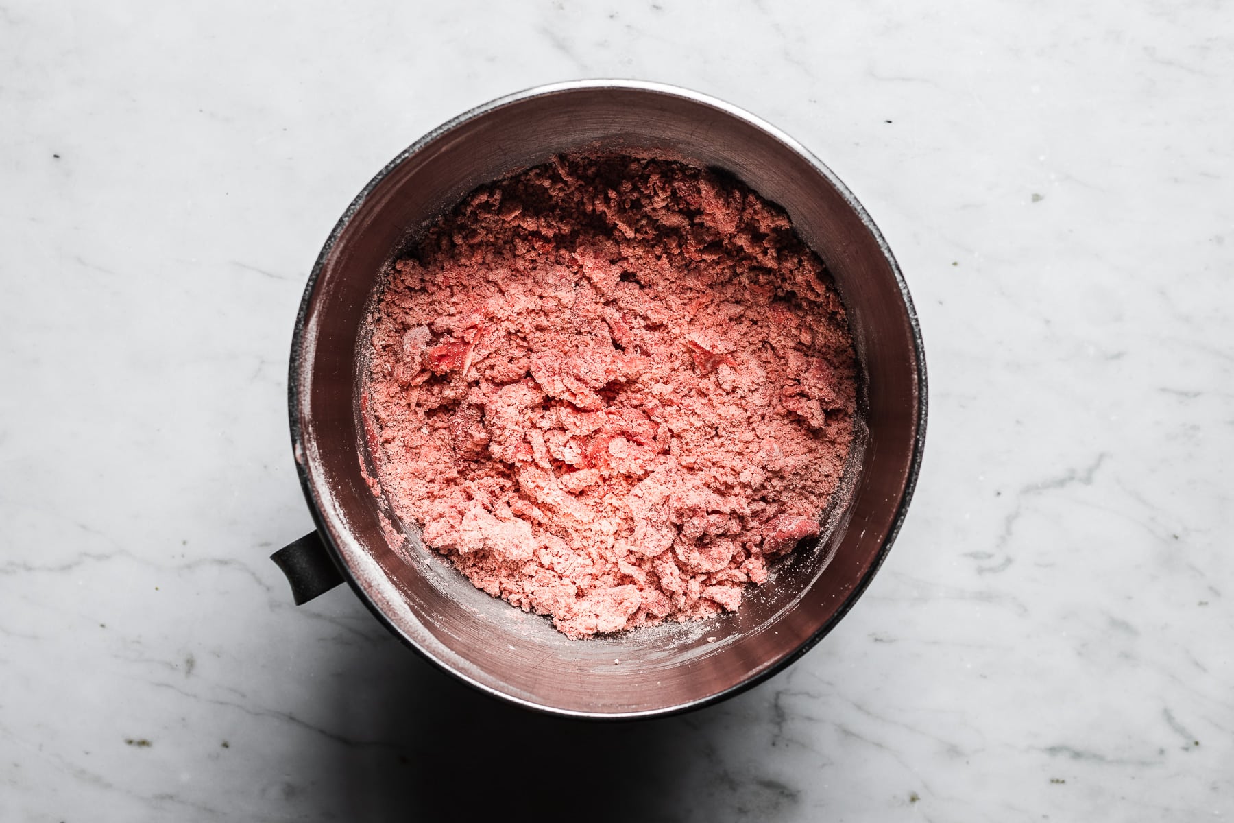 Dry ingredients blended with butter and sugar in a mixing bowl.