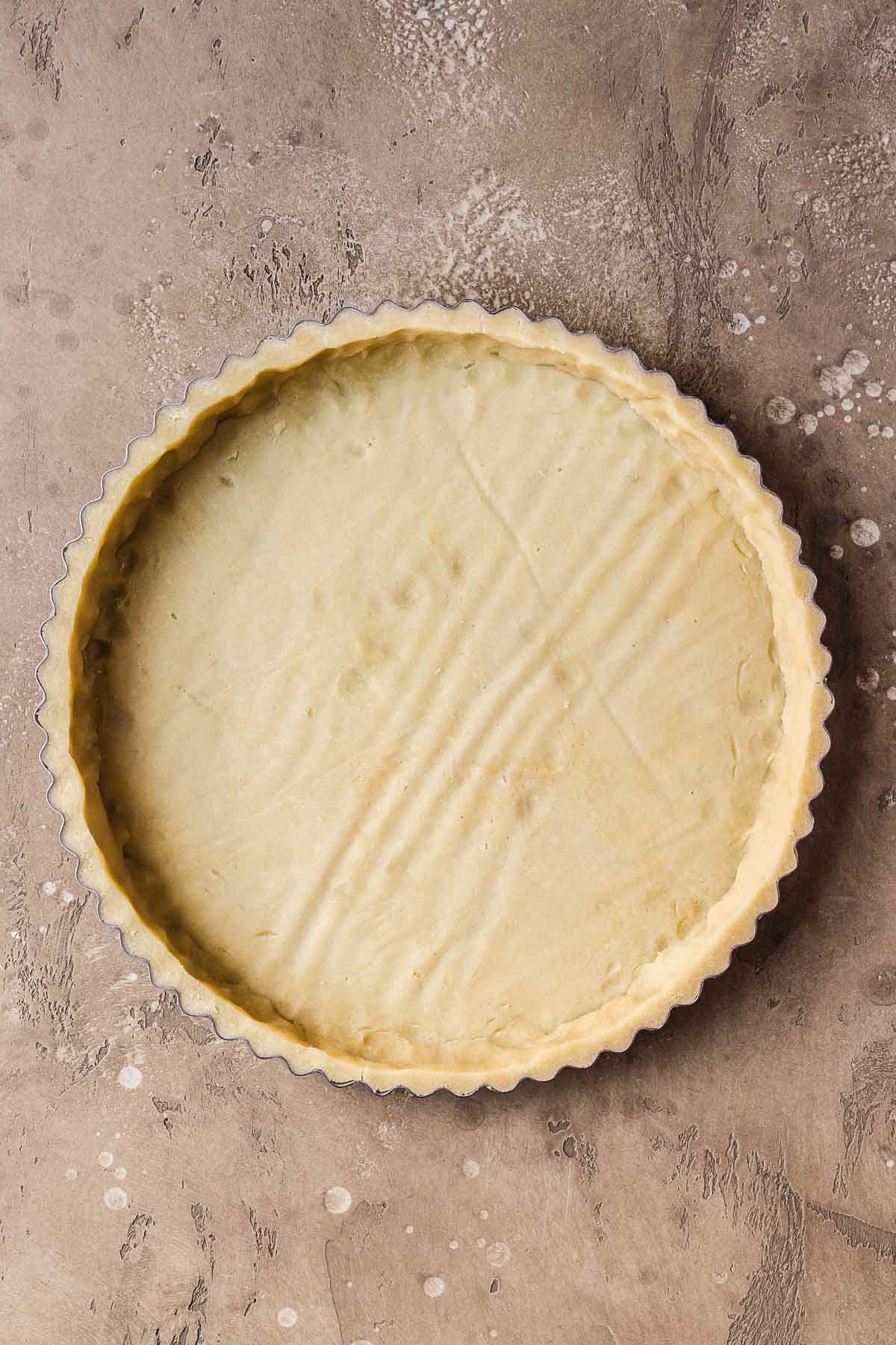 A pate sucree (shortcrust pastry) tart shell before baking.