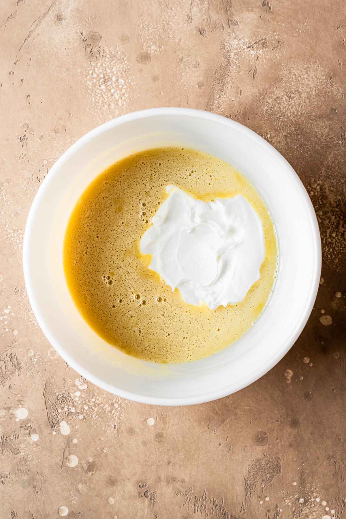 A ceramic bowl of wet ingredients plus yogurt.