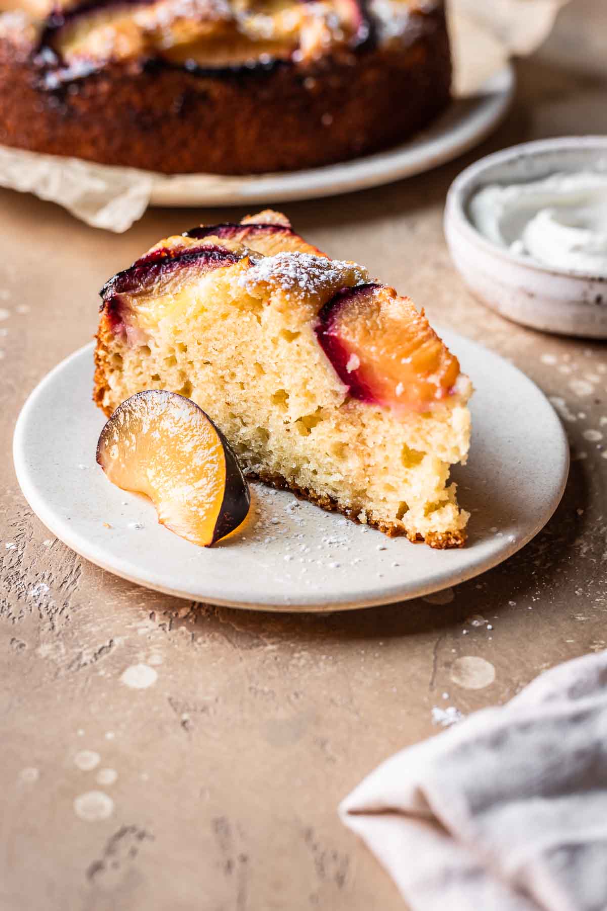 A slice of plum cake on a plate.