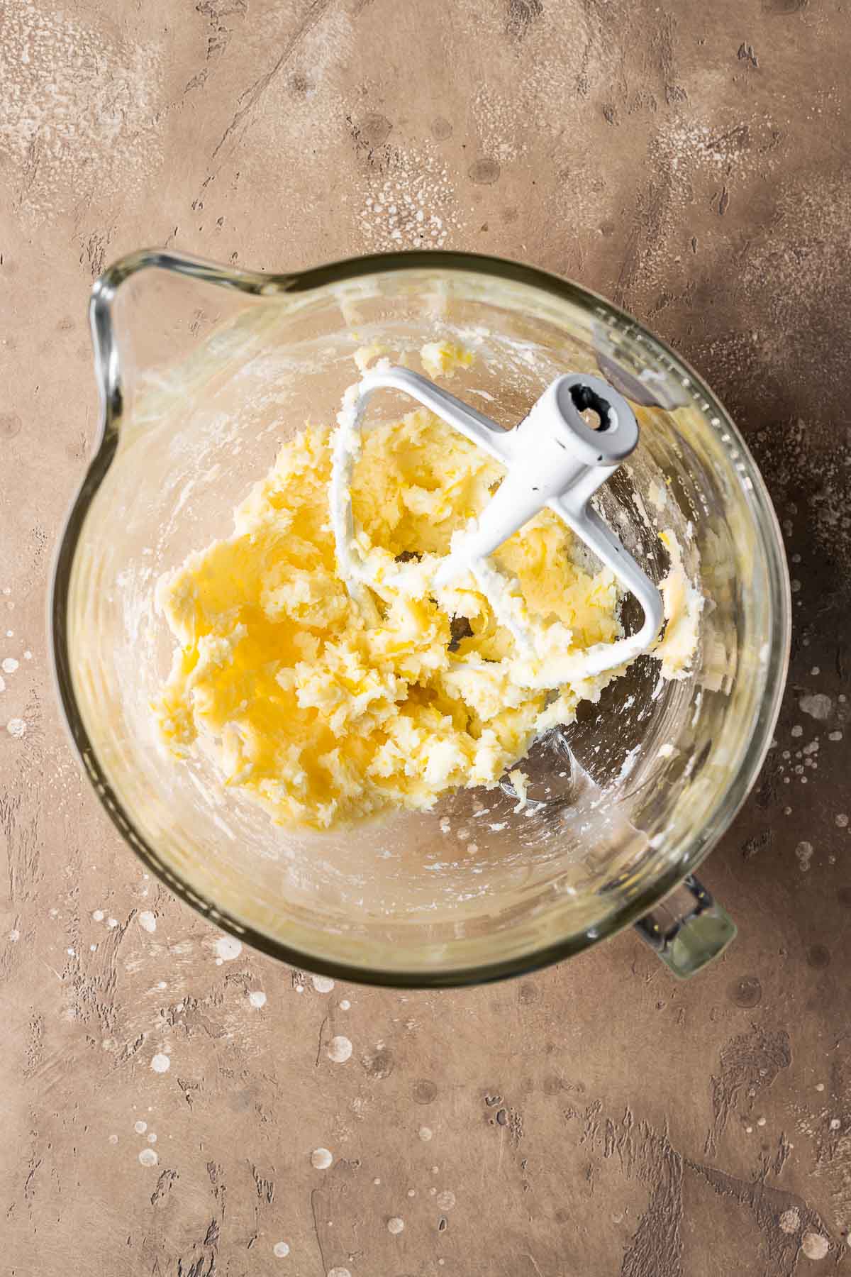 Wet ingredients for pastry dough in a clear glass mixing bowl.