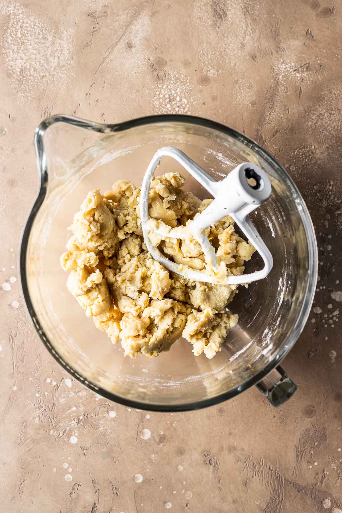 Finished tart dough in a glass mixing bowl.