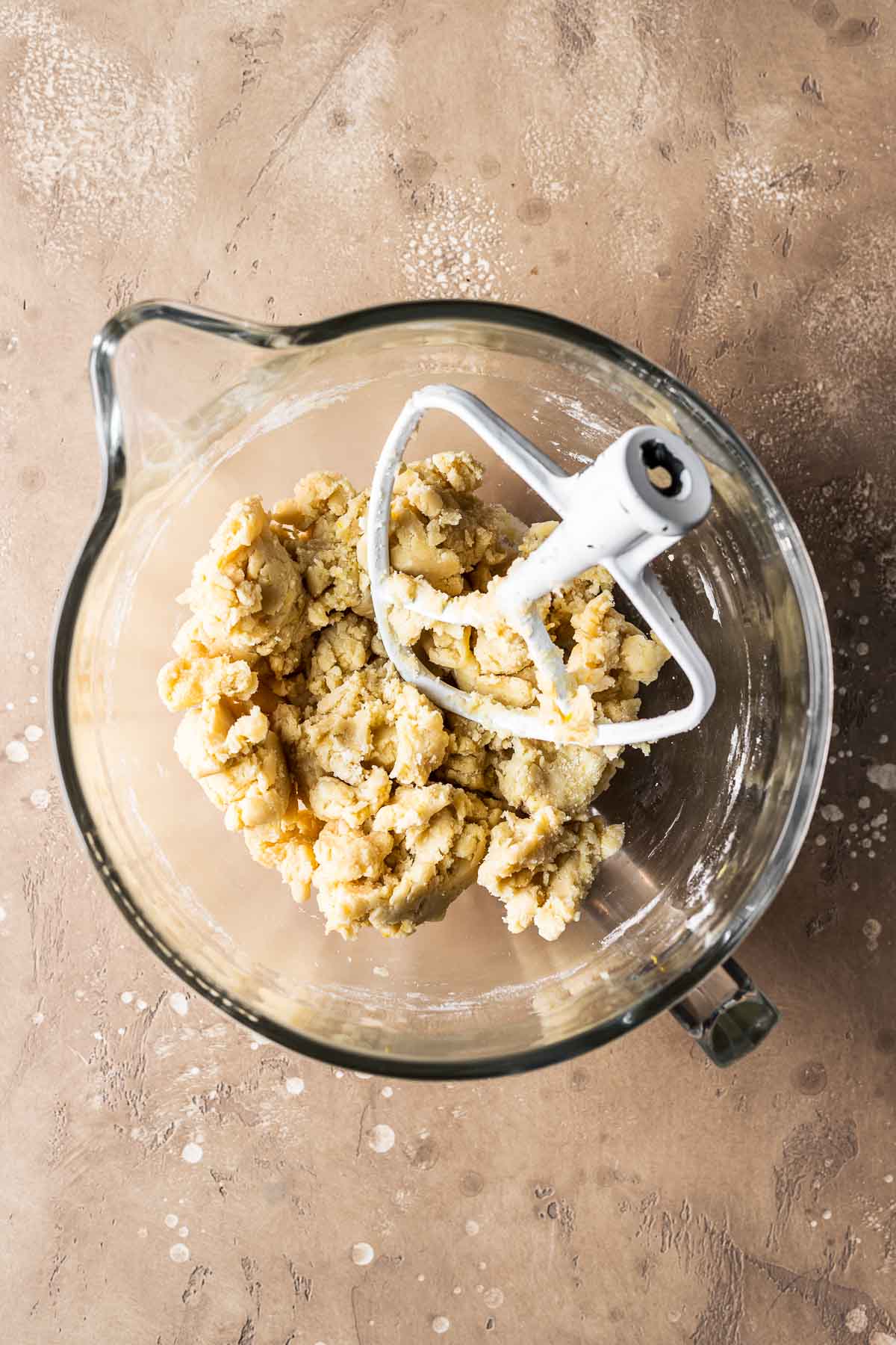 Finished tart dough in a glass mixing bowl.