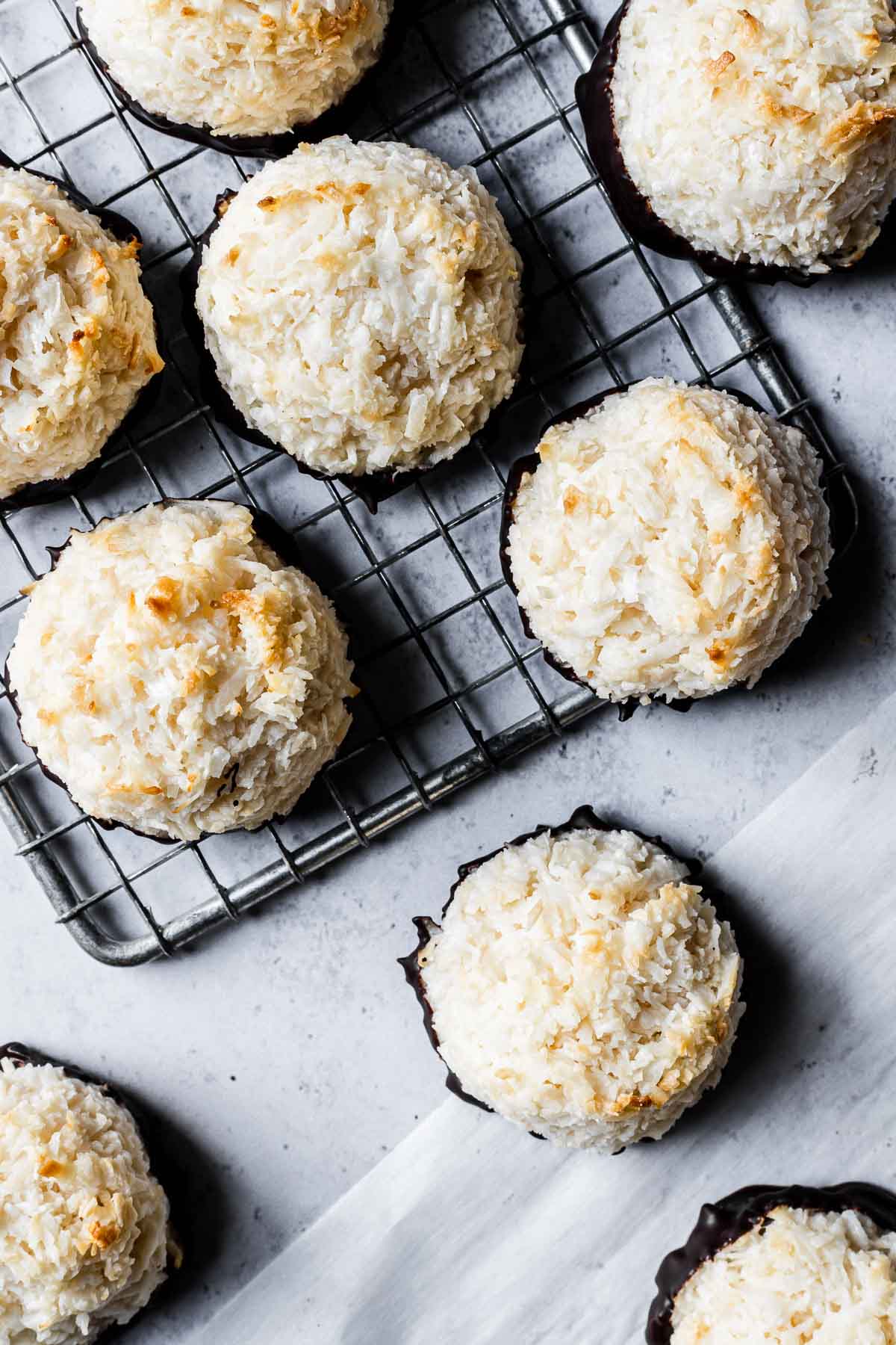 German coconut macaroons on a baking rack and parchment paper.