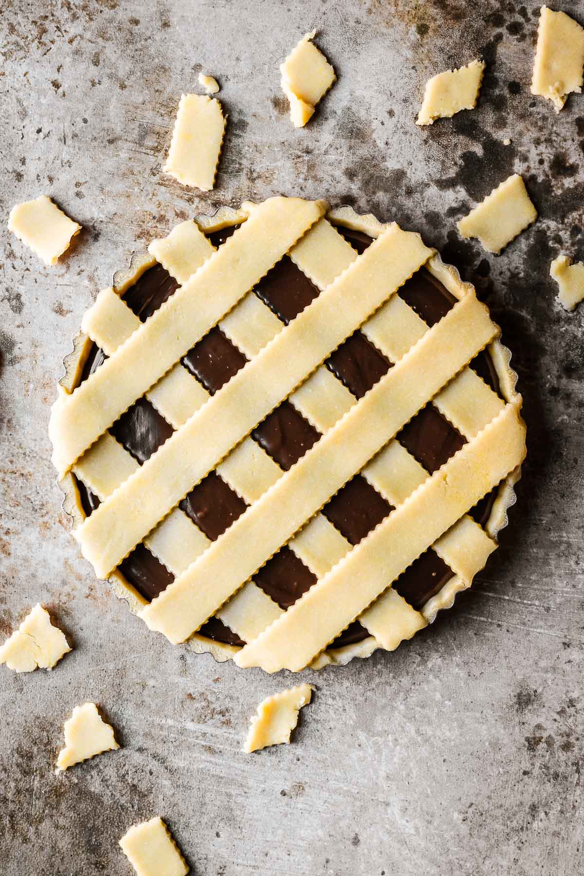 Trimmed lattice on an unbaked Italian nutella tart.