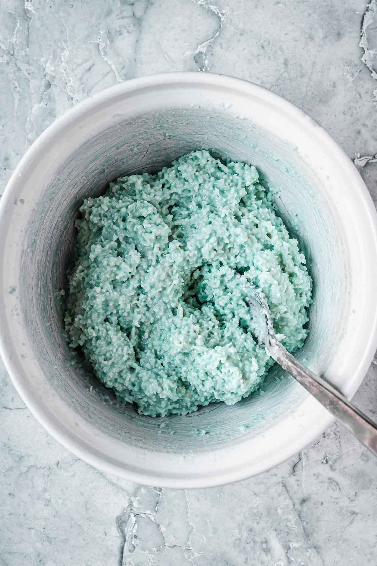 Blue coconut ice after being mixed with food coloring.