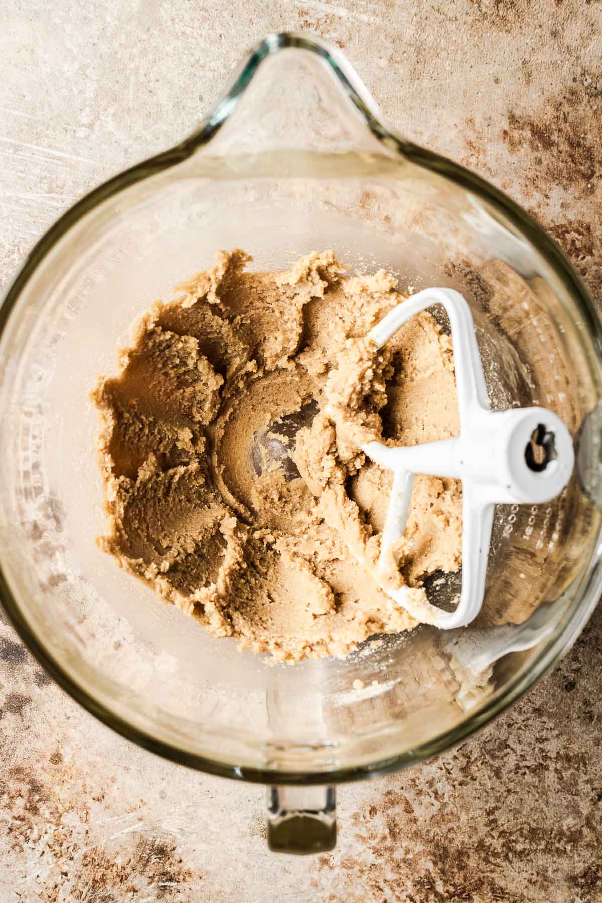 Creamed butter and sugar in a glass mixing bowl.