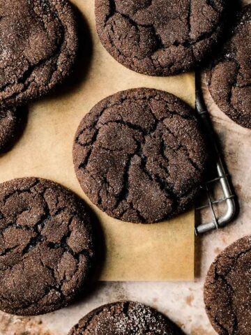 Chocolate gingerbread cookies on brown parchment paper.