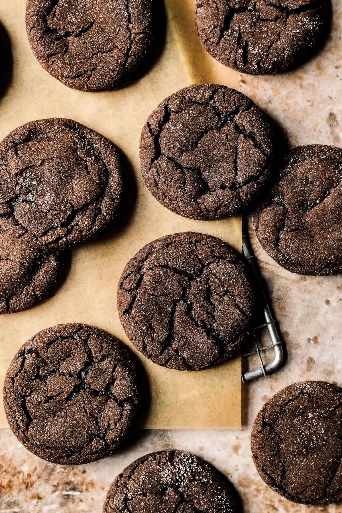 Chocolate gingerbread cookies on brown parchment paper.