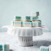 Blue and white candy squares on a white cake stand.