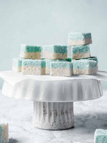 Blue and white candy squares on a white cake stand.