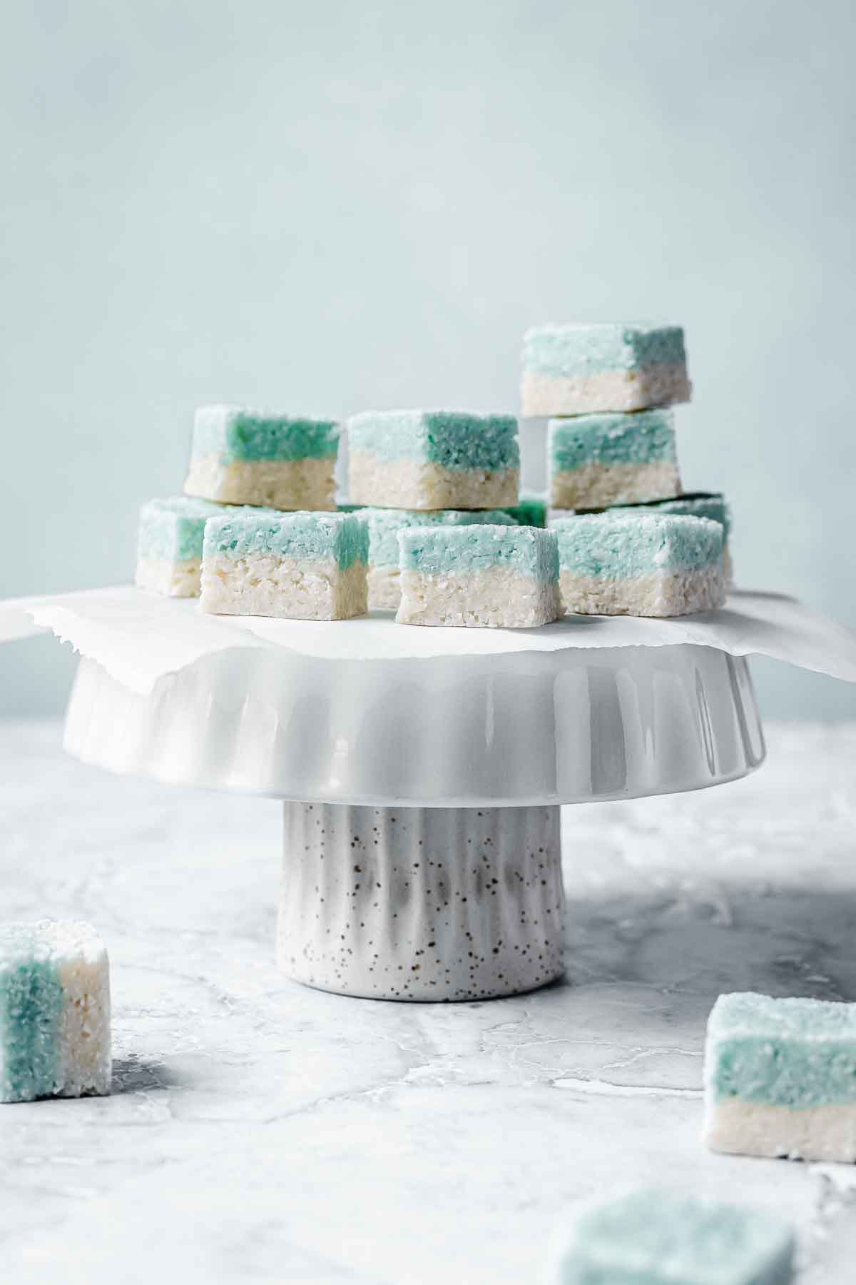 Blue and white candy squares on a white cake stand.