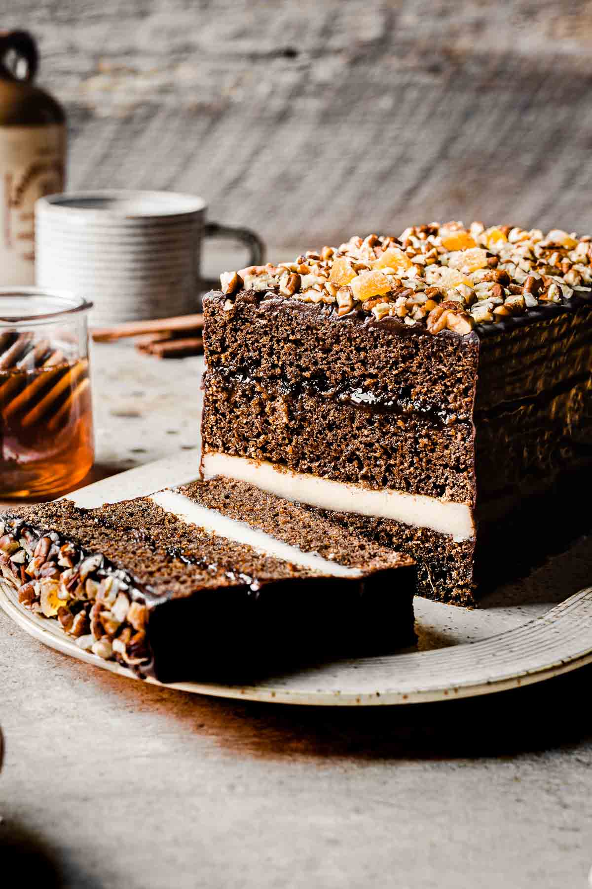 A piernik honey spice cake on a platter with a slice cut off.