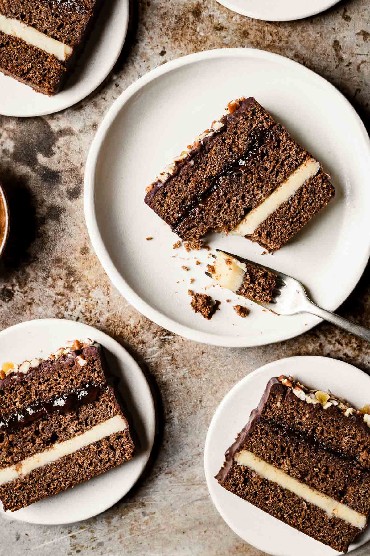 Slices of piernik honey spice cake on tan plates.