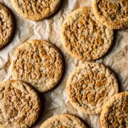 Round butter cookies on brown parchment paper.