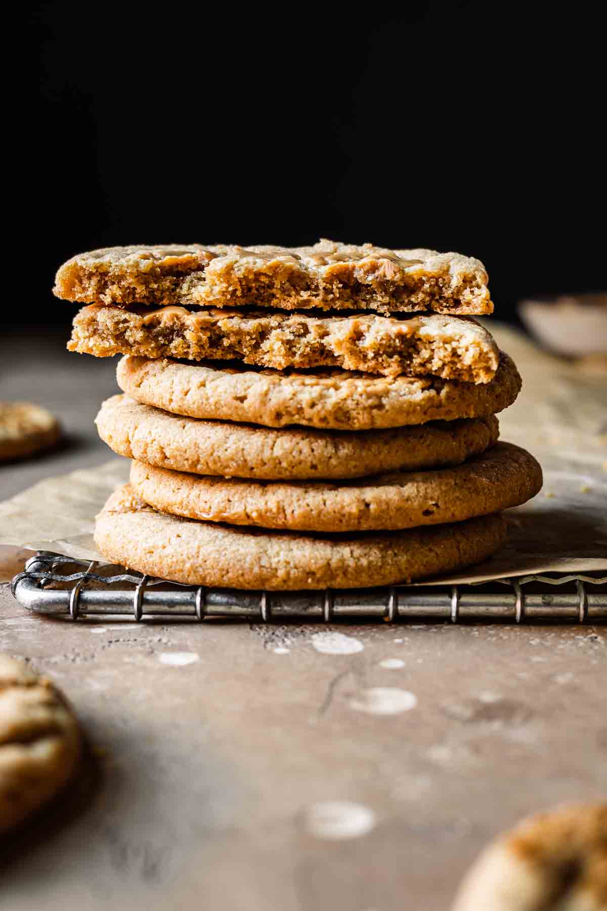 Stack of round cookies with two broken in half to show inside.