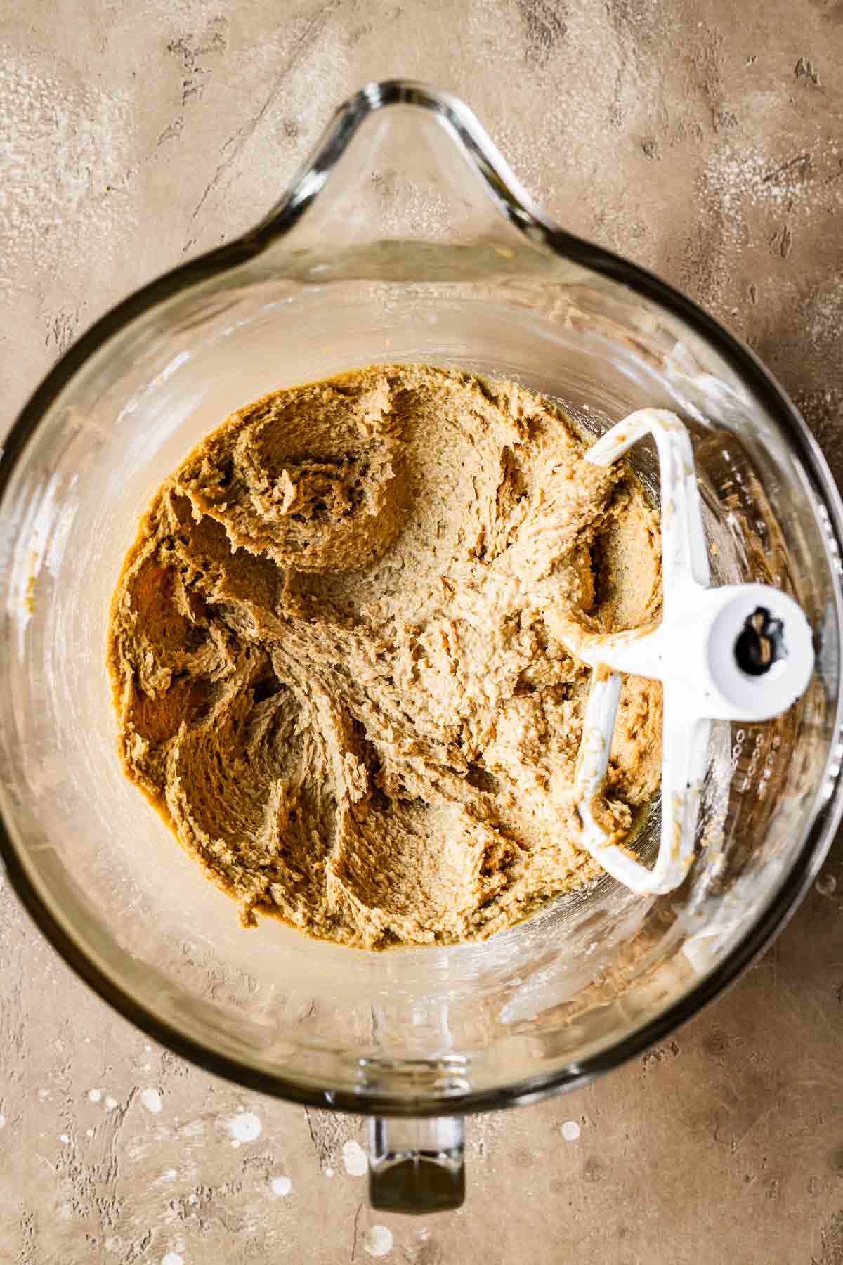 Mixing bowl with creamed butter and sugar for cookie dough.