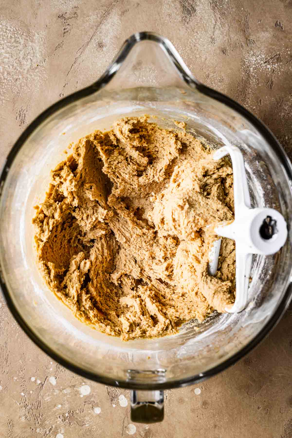 A glass bowl of finished biscoff butter cookie dough.