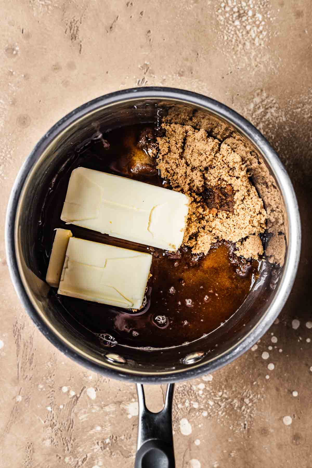 A pot with unmelted butter and brown sugar.