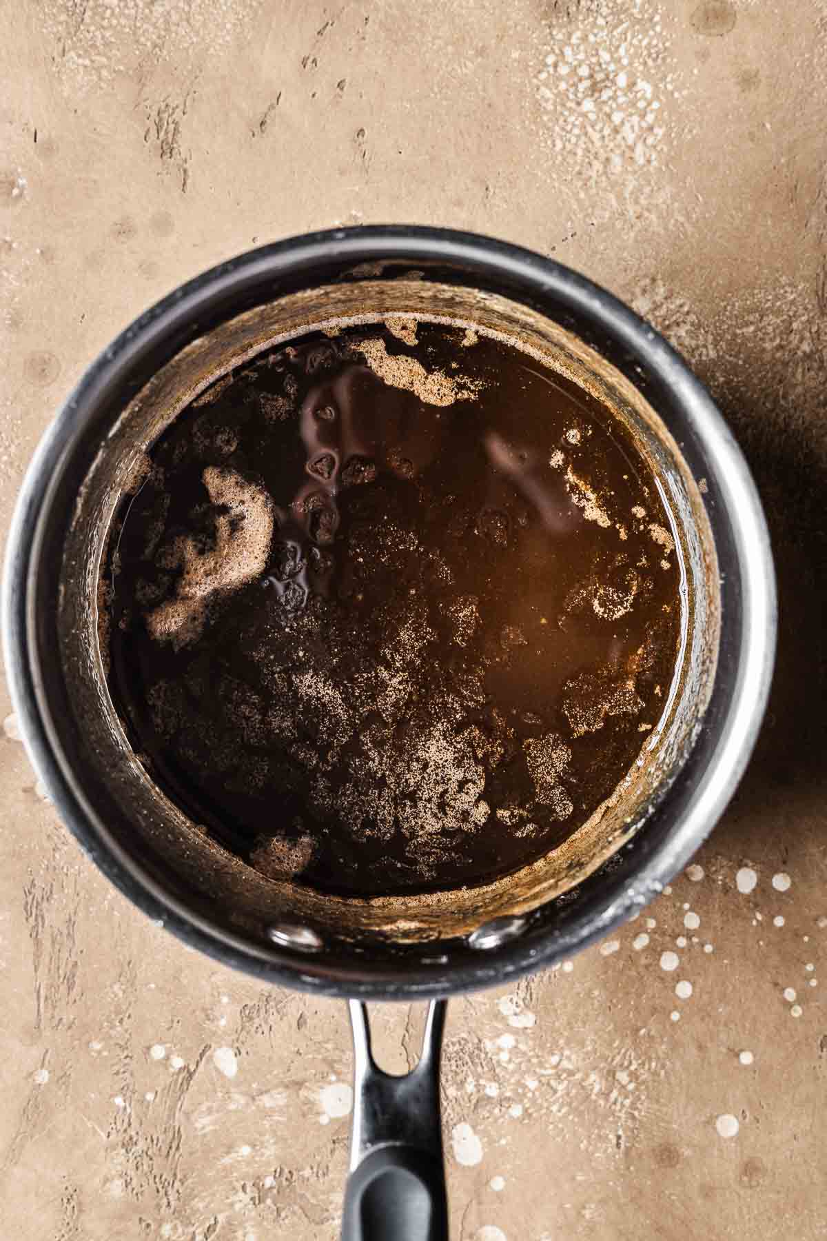 A pot with melted butter and brown sugar.