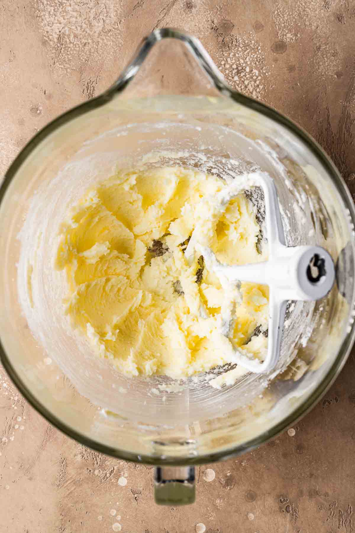 A mixing bowl with butter and sugar blended together.