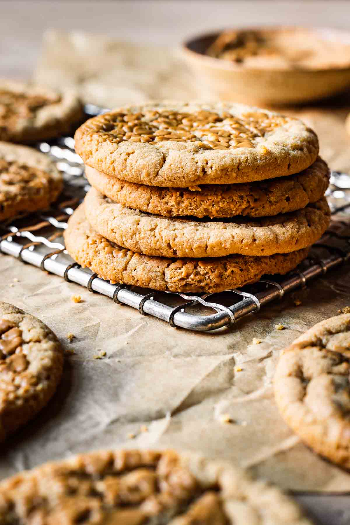 Four round cookies stacked on a cooling rack.