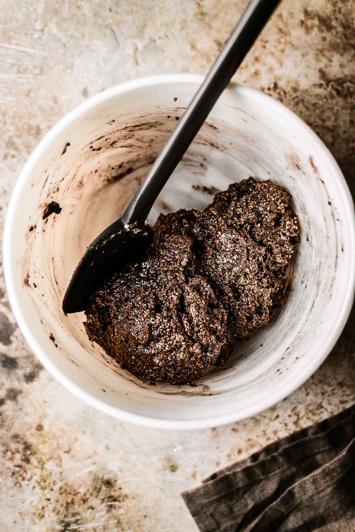 Final batter for baci di Alassio hazelnut cookies in a white ceramic mixing bowl.