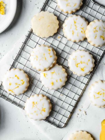 Lemon shortbread cookies with white glaze and lemon zest sprinkled on top