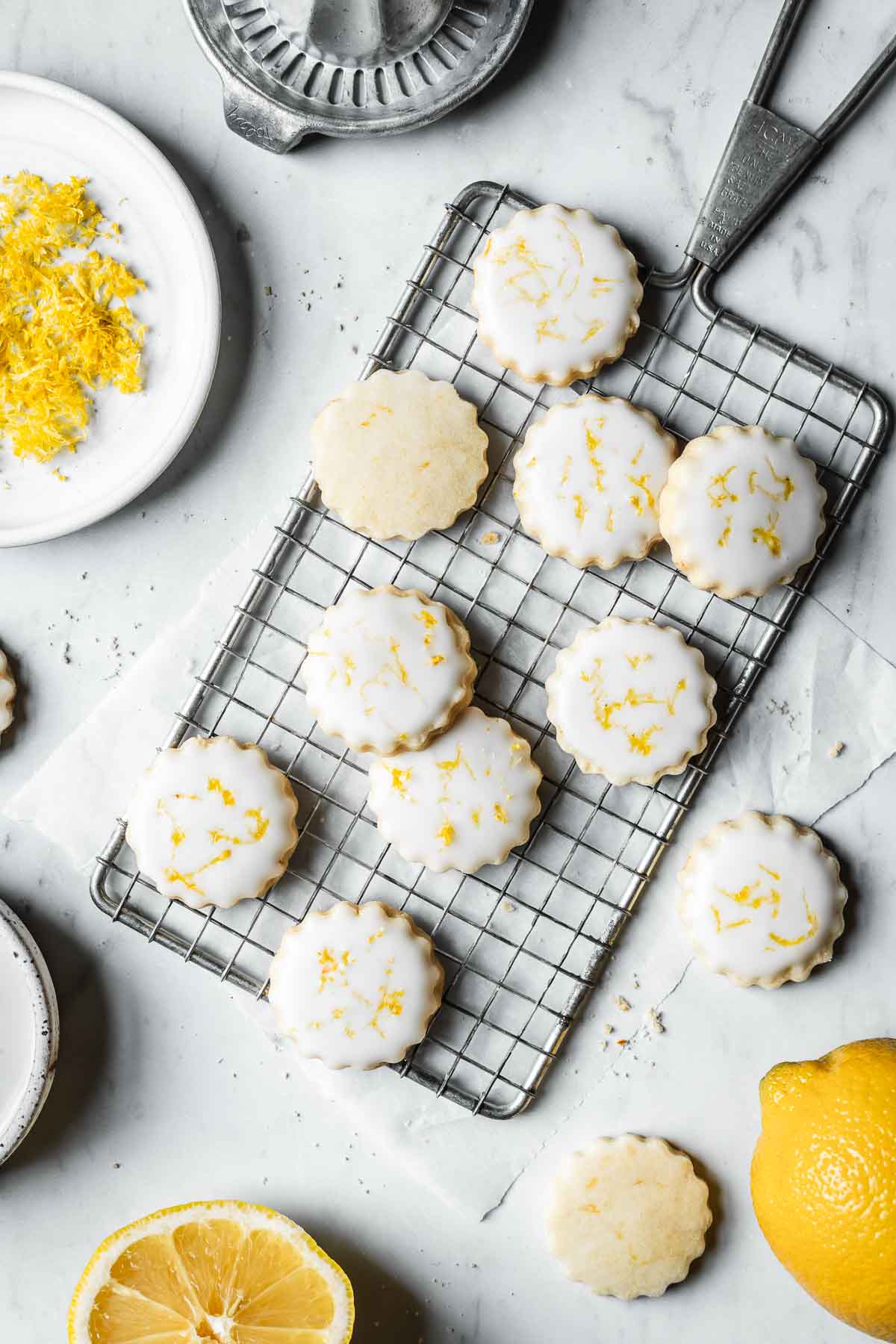 Lemon shortbread cookies with white glaze and lemon zest sprinkled on top