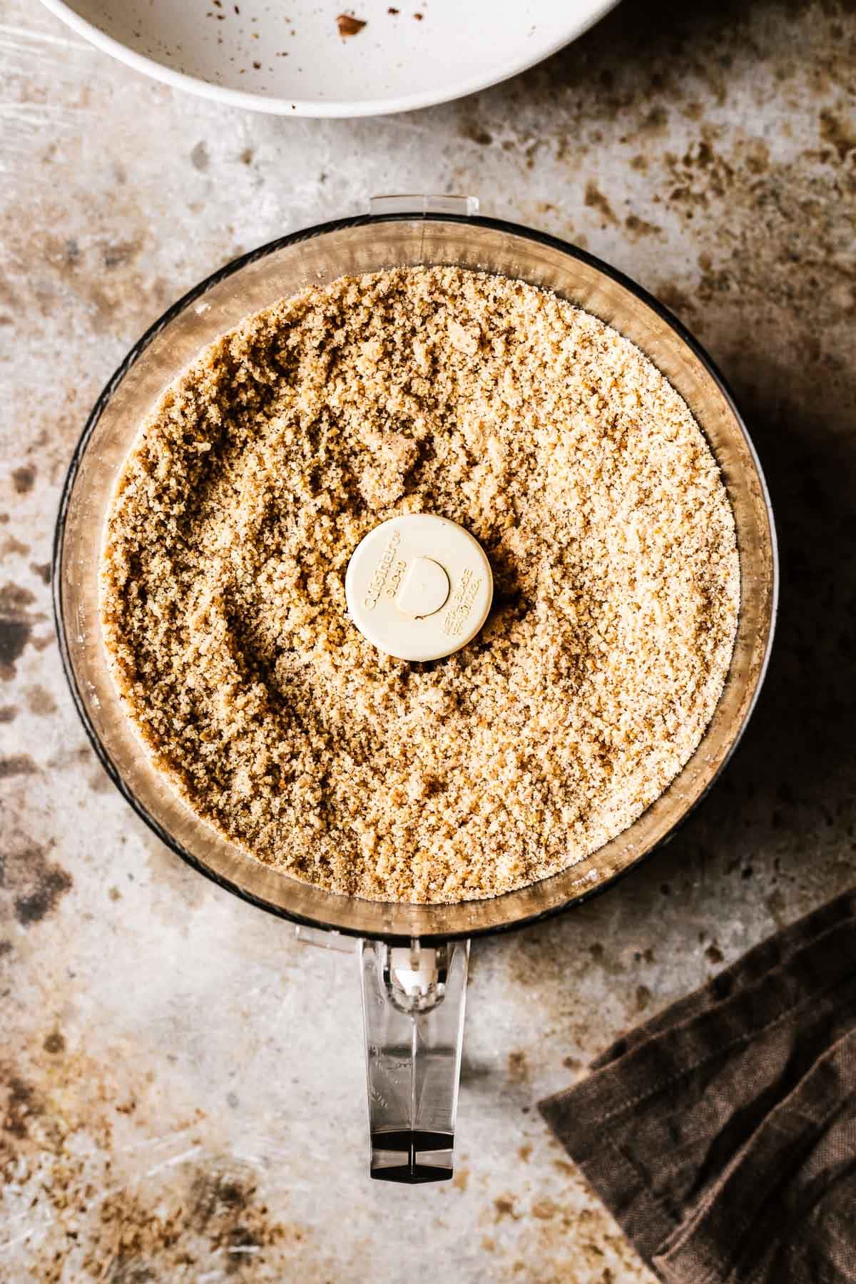 Finely round hazelnuts and sugar in a food processor.