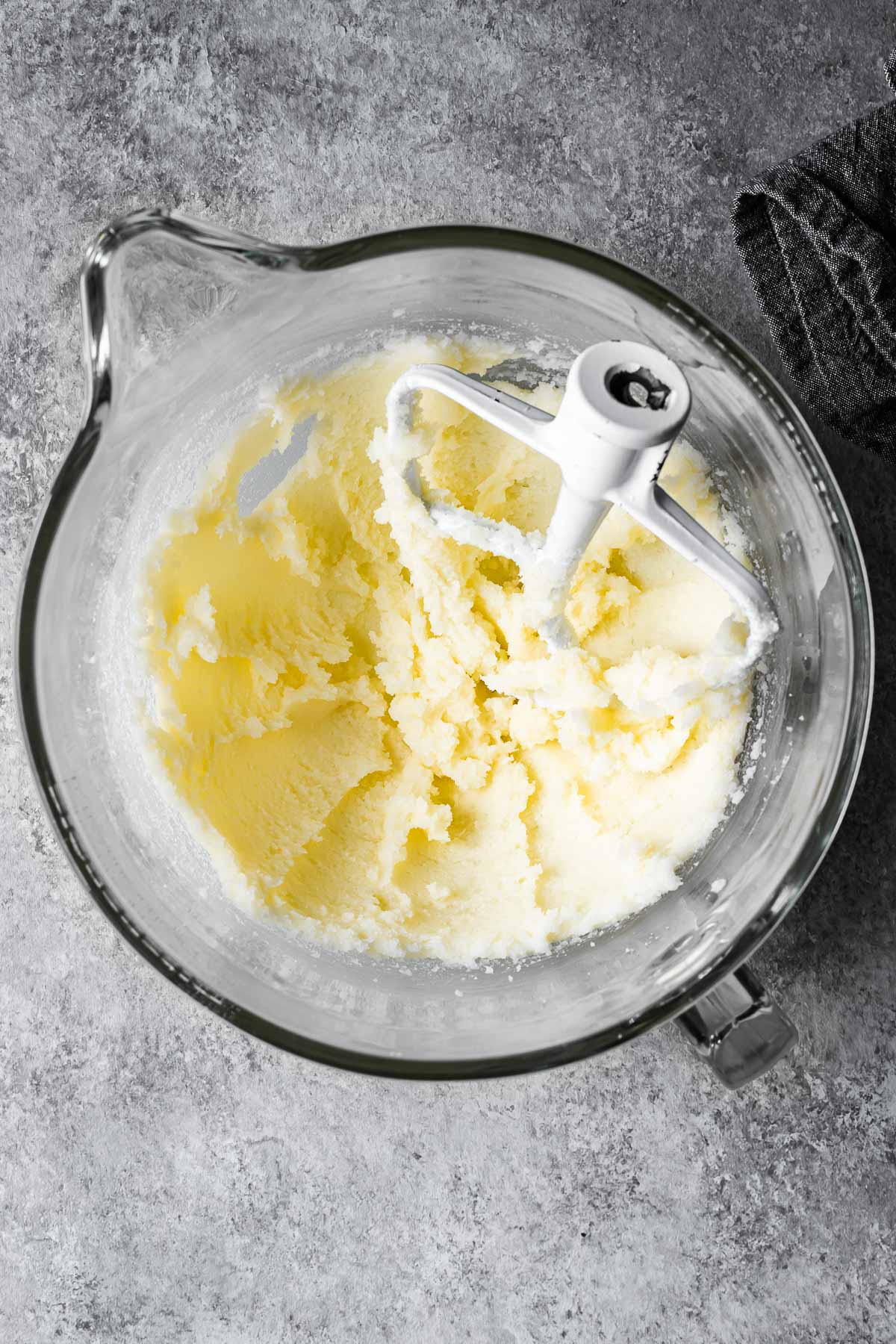 Creamed butter and sugar in a glass mixing bowl.