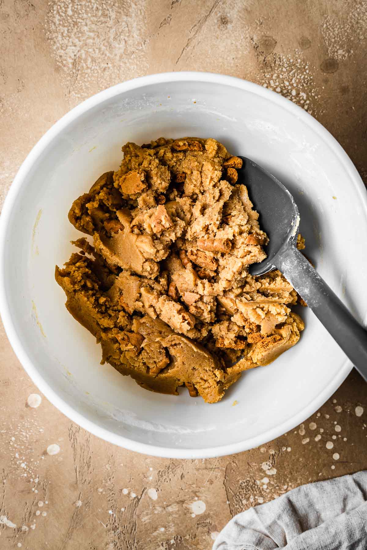 Finished dough for biscoff blondie bars in a white ceramic bowl.