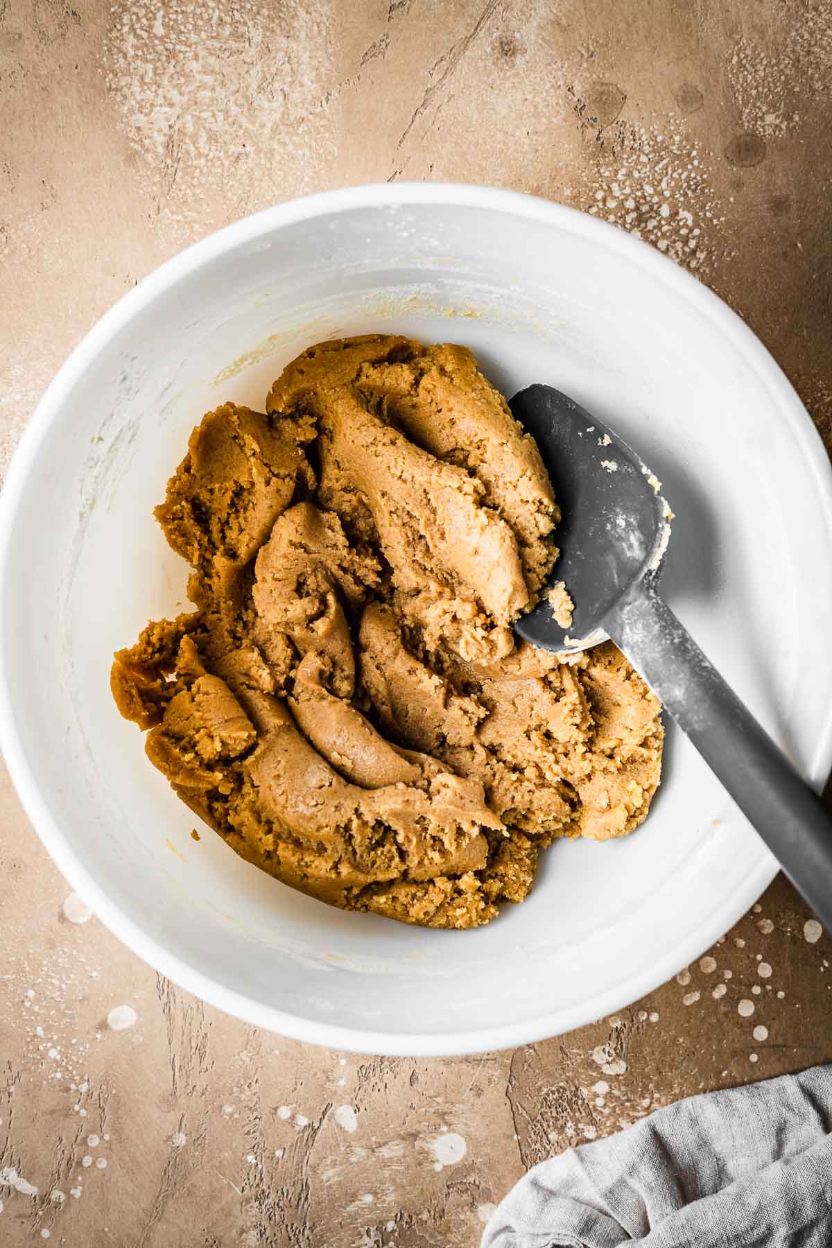 Dough for bar cookies in a white mixing bowl.