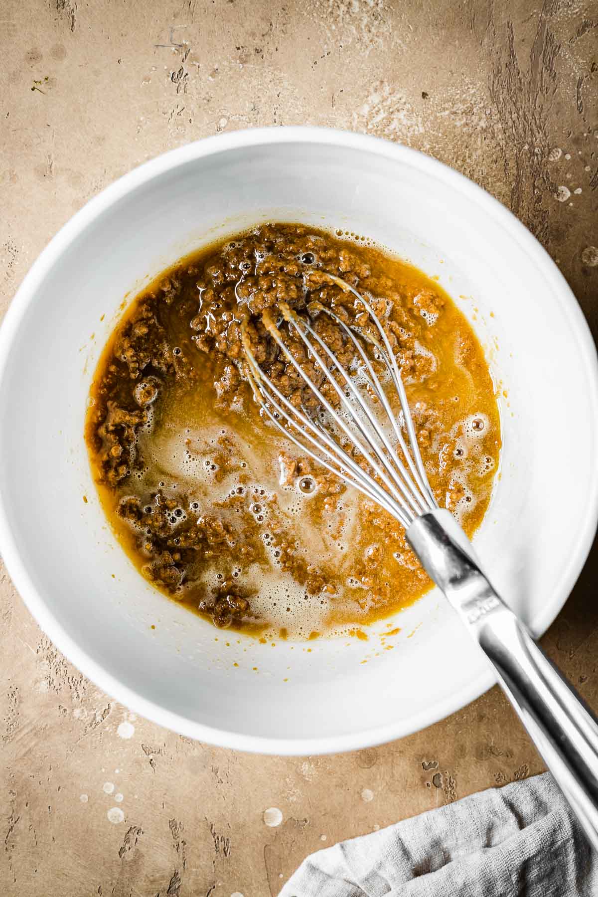 Melted butter, sugar and biscoff spread in a mixing bowl.