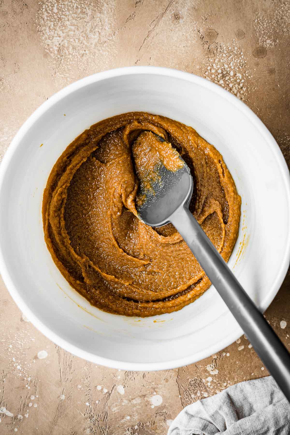 Eggs blended with sugar and butter in a mixing bowl.