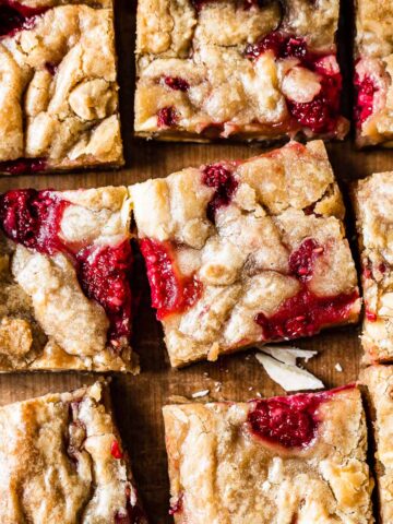 A close up of nine squares of raspberry white chocolate blondies.