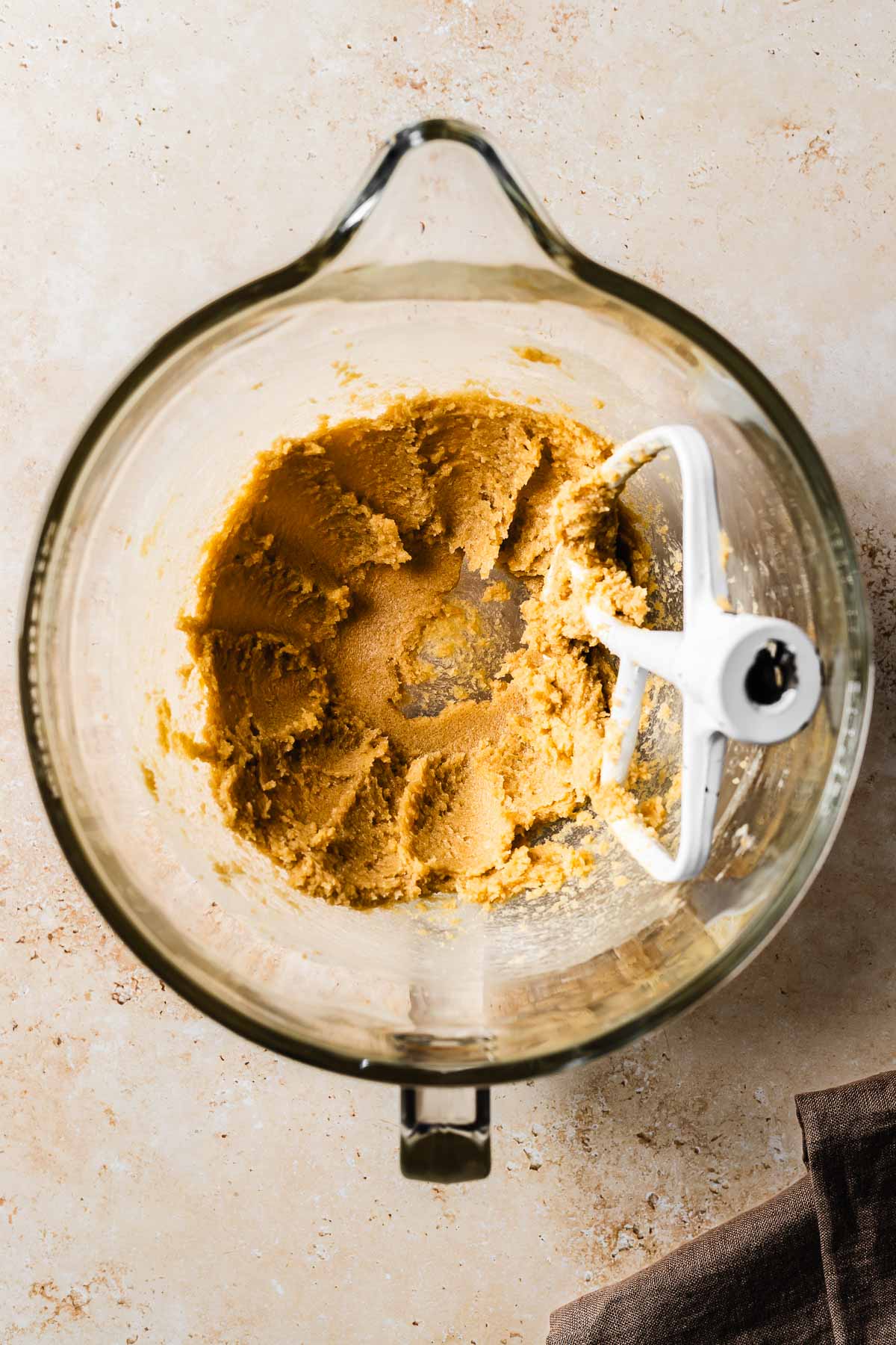 Creamed butter and sugar in a glass mixing bowl.