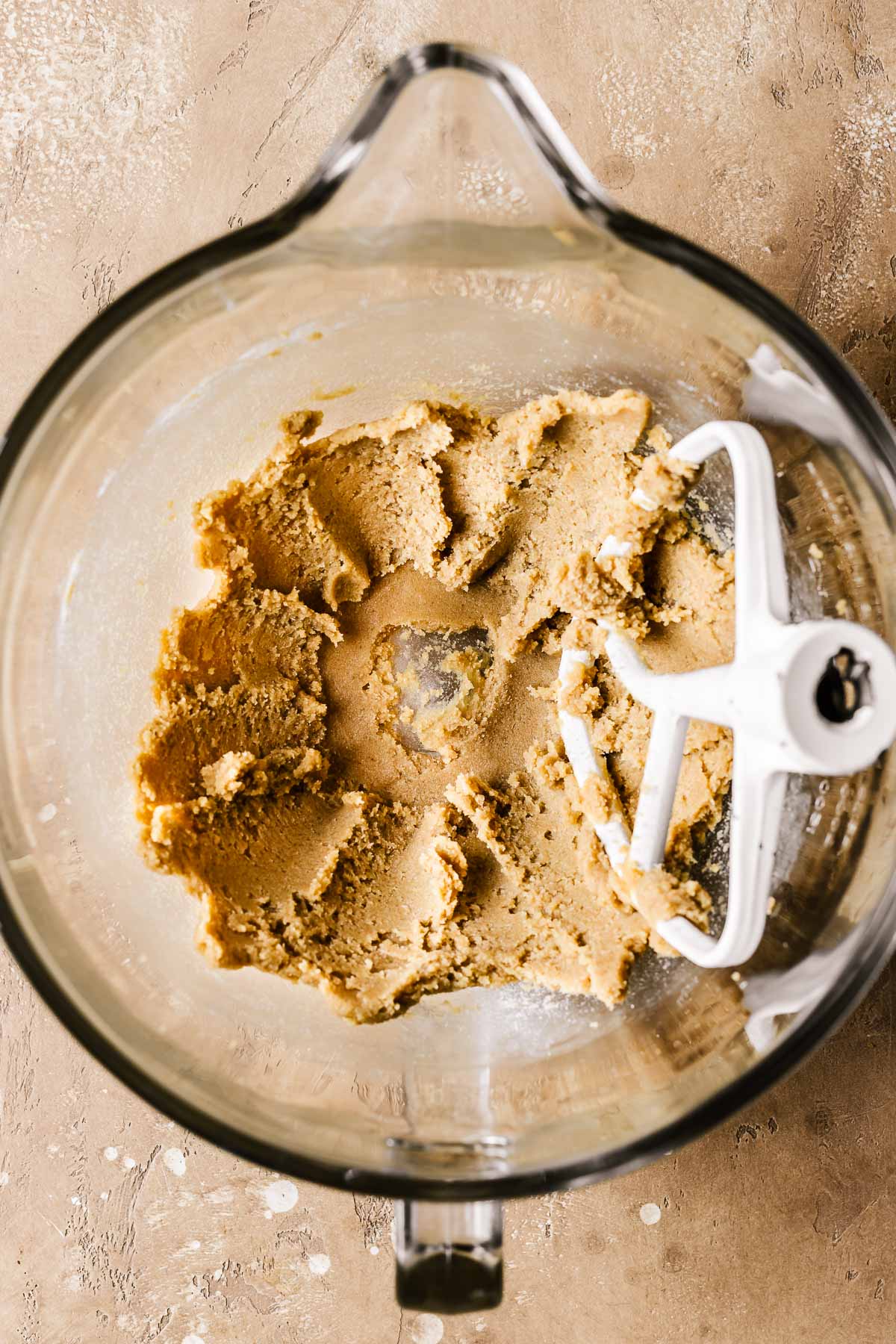 Creamed butter and sugar in a clear glass mixing bowl.