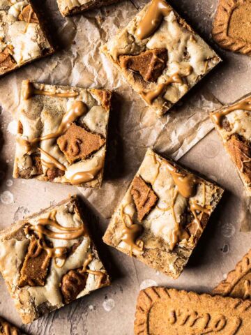 Cookie butter squares on brown parchment paper.