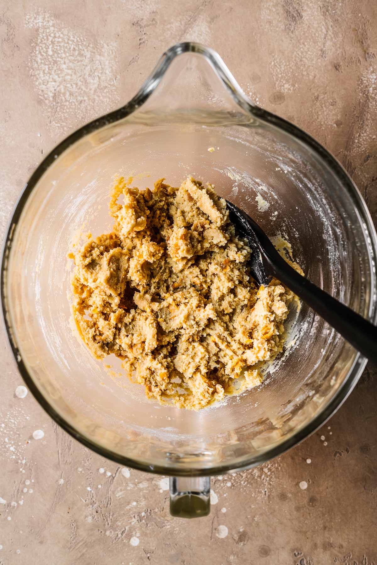 Final dough for mango cookies in a clear glass mixing bowl.