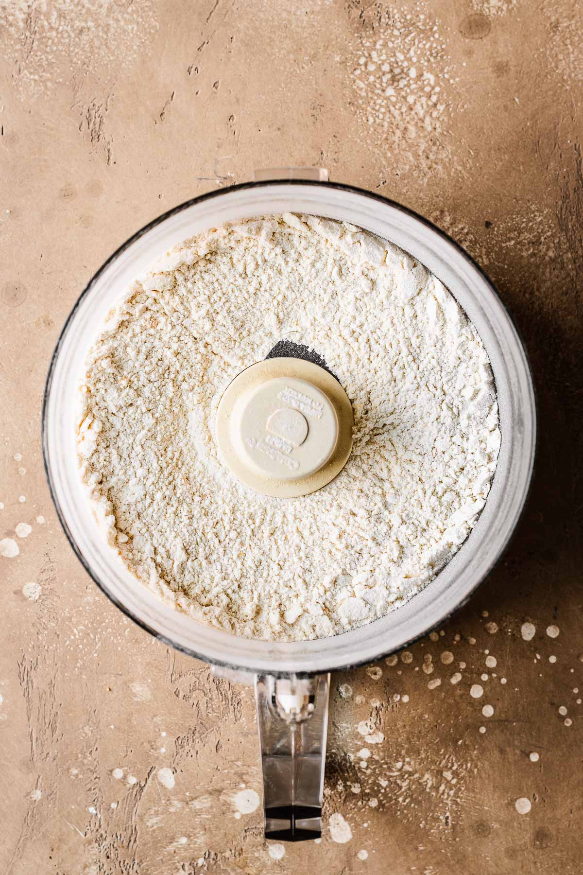 Dry ingredients for cookie dough in a food processor.