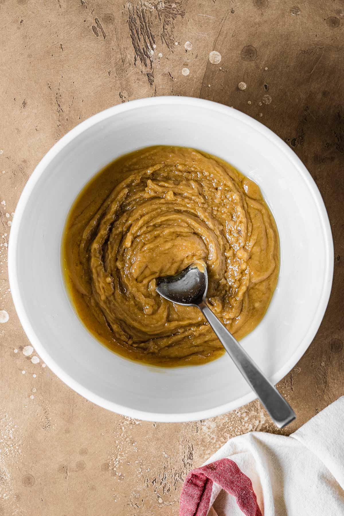A mixing bowl with eggs and vanilla added to butter and sugar mixture.