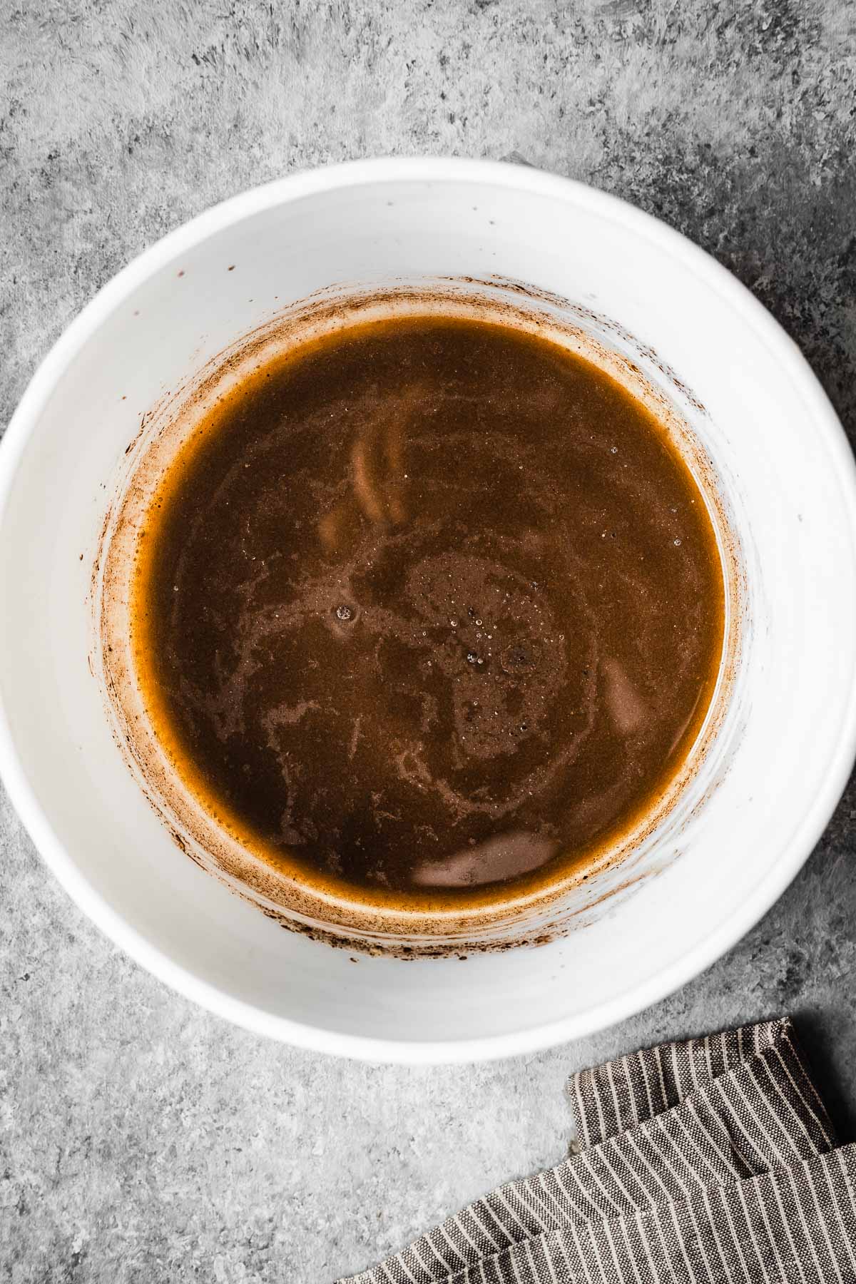 Melted butter, oil and cocoa powder in a mixing bowl.