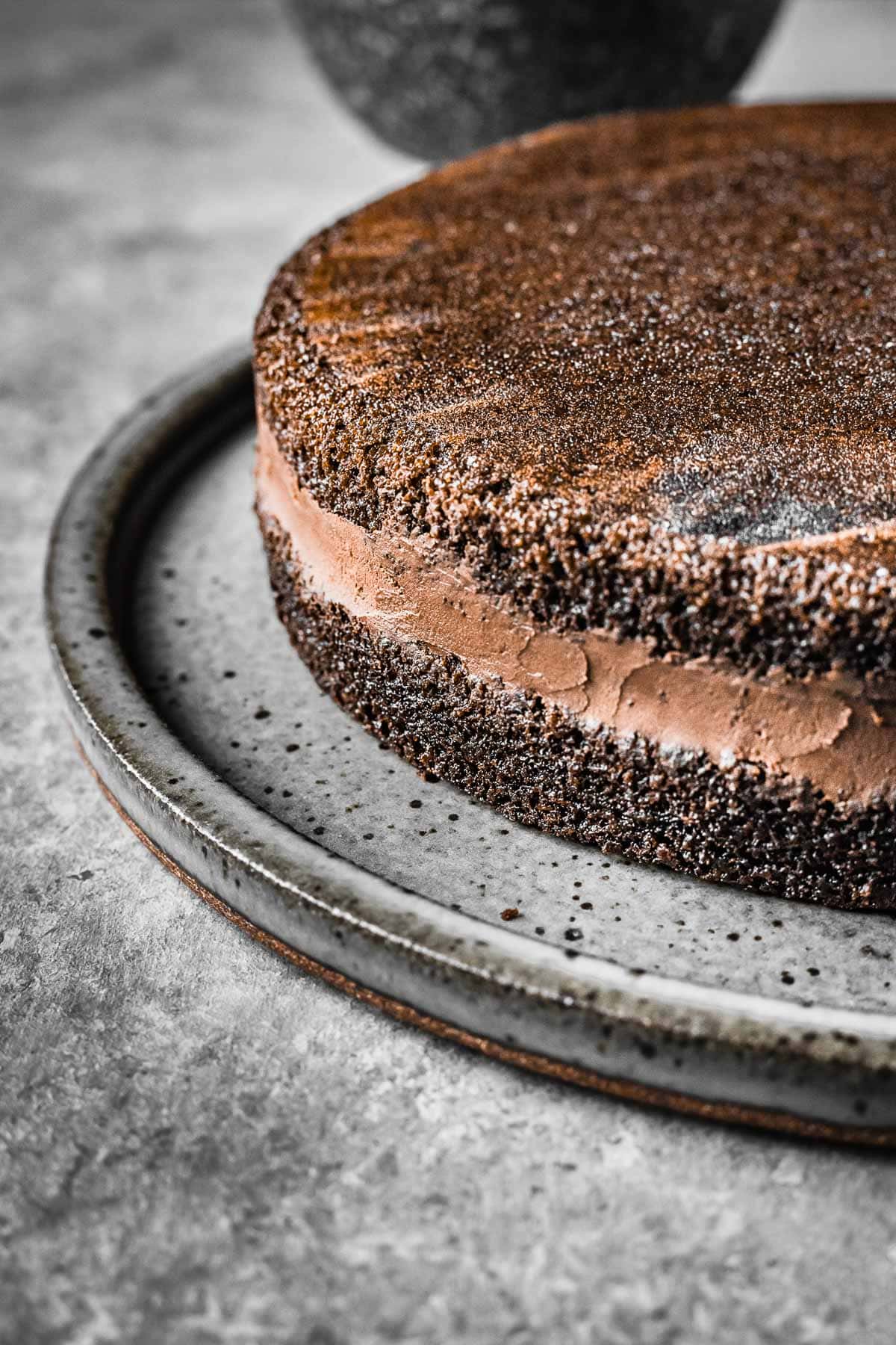 A torted chocolate cake with a middle layer of whipped chocolate ganache filling.